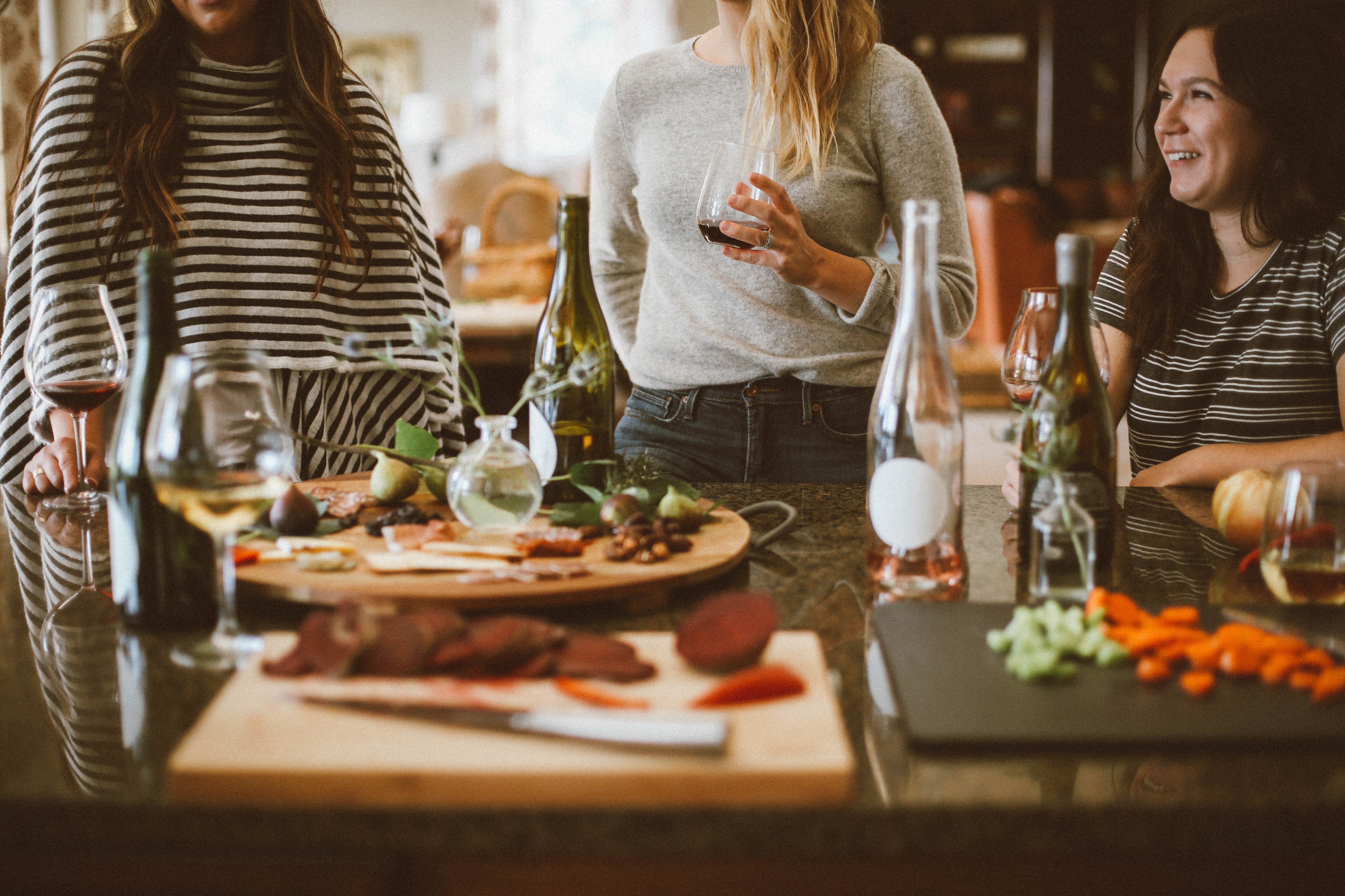 A group of women gather around a holiday meal